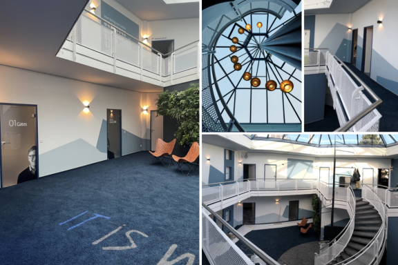 Moderne Innenarchitektur mit Treppe, Pflanzen und stilvollen Beleuchtungselementen.